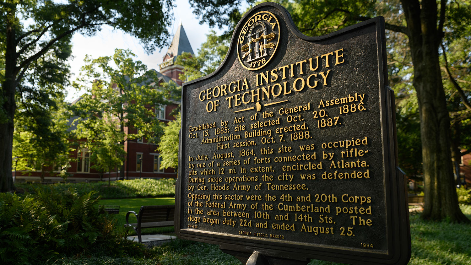 Historical marker on Georgia Tech's campus in Harrison Square. The marker reads "Georgia Institute of Technology | Established by Act of the General Assembly Oct. 13 1885; site selected Oct. 20, 1886. Administration building erected 1887. First session, Oct. 7, 1888. In July, August 1864, this site was occupied by one of a series of forts connected by rifle-pits which 12 mi. in extent, encircled Atlanta. During siege operations the city was defended by Gen. Hood's Army of Tennessee. 