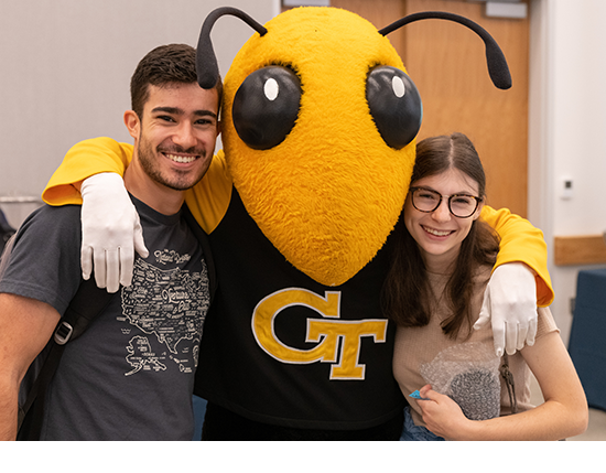 two students smiling and posing with Buzz