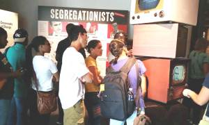 Students at a museum exhibit about segregationists